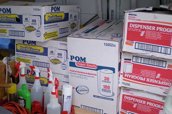 cleaning supplies including toilet paper and paper towels